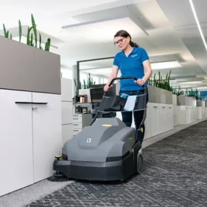 woman scrubbing floor with large carpet machine